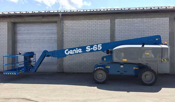 A telescopic boom lift waiting to be deployed on site